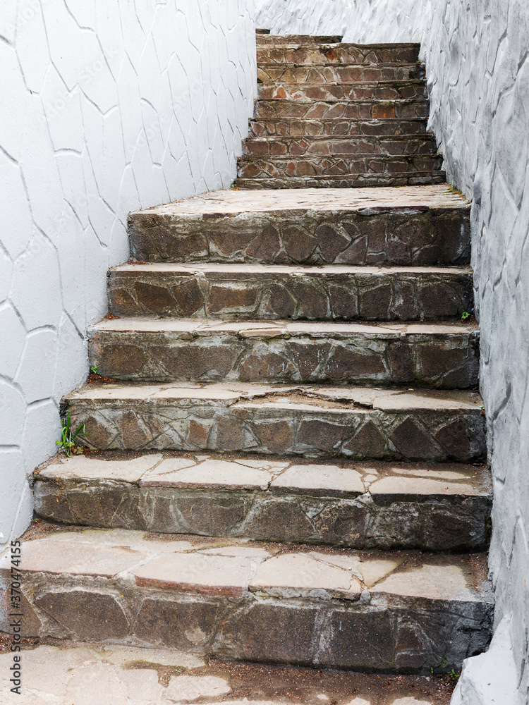Background old stairs made of natural stone leads upstairs Background old stairs made of natural stone leads upstairs