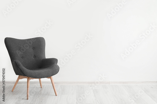 Comfortable armchair near wall in room