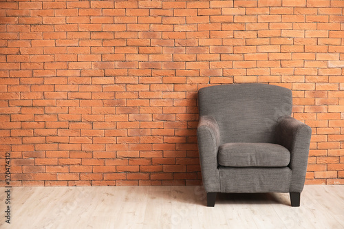 Comfortable armchair near wall in room