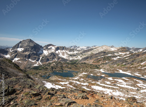 VIew on lower and upper Gwillim Lakes from above, snow, rocky terrain, Valhalla Provincial park, West Kootenays, BC photo