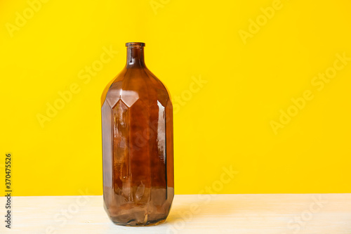 Beautiful vase on table against color background
