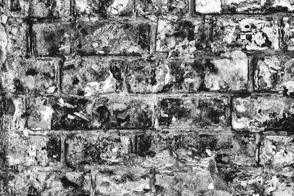 Fototapeta premium Close-up bright vintage brick wall background. Brick texture with scratches and cracks