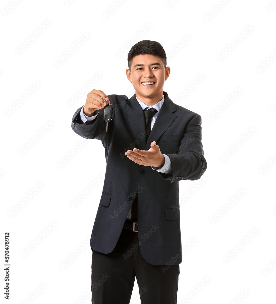 Happy Asian businessman with car key on white background Happy Asian businessman with car key on white background