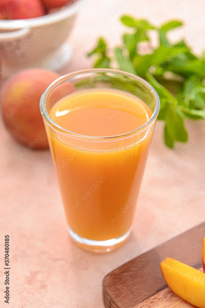 Glass of tasty peach juice on color background Glass of tasty peach juice on color background