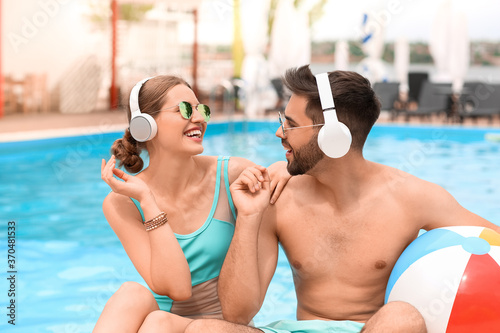 Young couple listening to m...