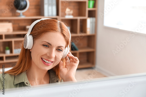 Woman with headphones worki...