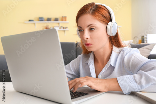 Woman with headphones worki...