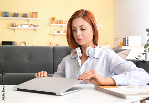 Woman with headphones worki...