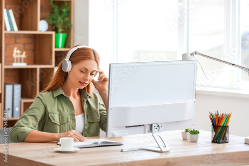 Woman with headphones worki...