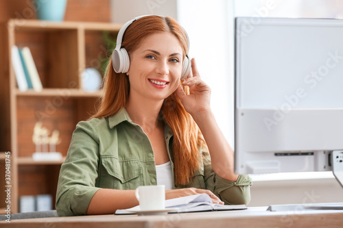 Woman with headphones worki...