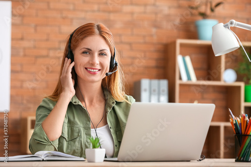 Woman with headset working ...
