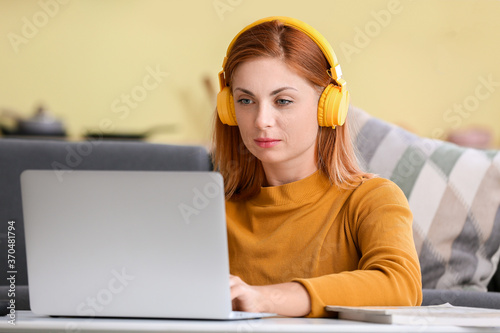 Woman with headphones worki...