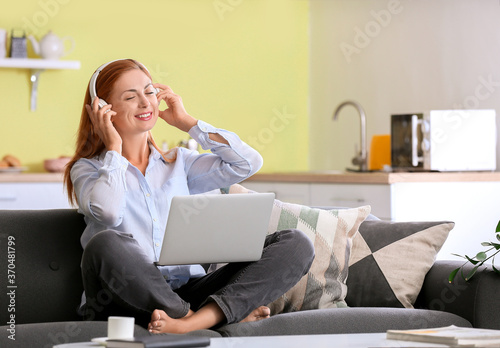 Woman with headphones worki...