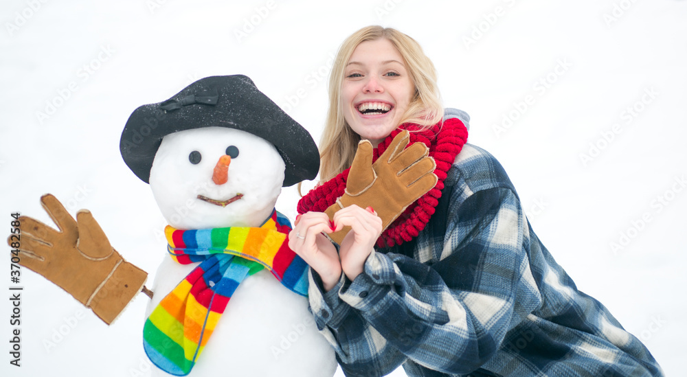 Winter scene with happy people on white snow background. Snowing winter beauty fashion concept. Winter weather in park.