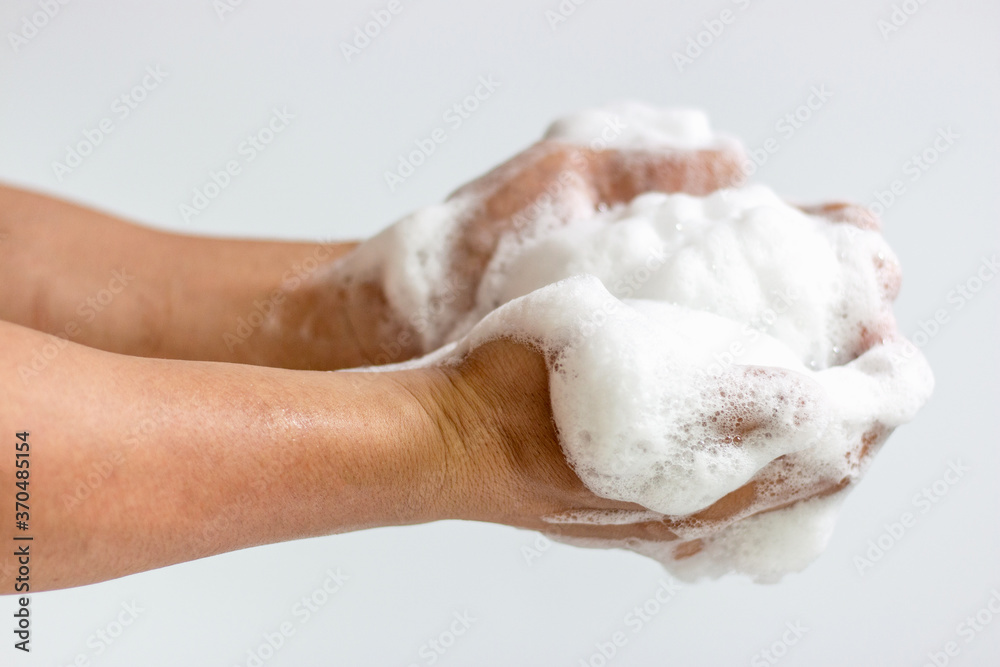 A large amount of foam on men's hands on white background, front view A large amount of foam on men's hands on white background, front view