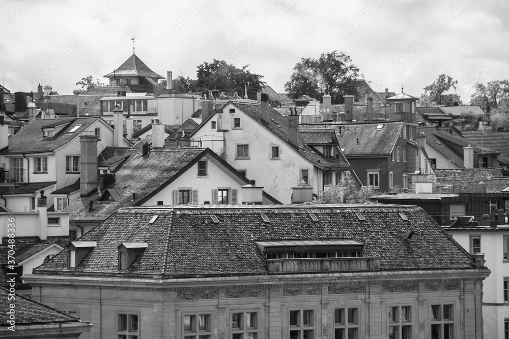 Picturesque view of the tile roofs of Historical buildings in the center of Zurich. Black and white cityscape.