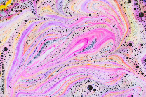 Colorful rainbow bath foam with bubbles in the water. Galaxy imagination. Marble texture effect. Beauty and luxury background. Flat lay, top view, abstract art.
