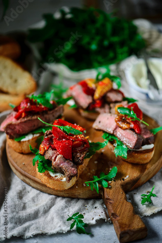 Crostini with steak with roasted bell pepper. style rustic