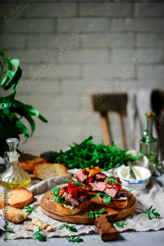 Fototapeta Naklejka Na Ścianę i Meble -  Crostini with steak  with roasted bell pepper. style rustic