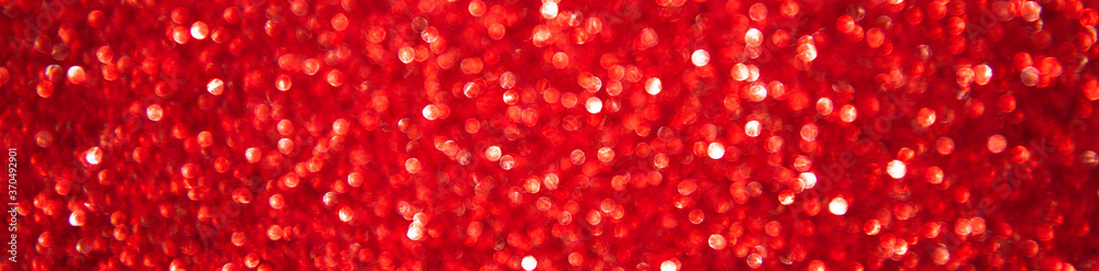 Abstract glitter christmas red background. Shimmer bright background with bokeh defocused red lights. Shiny gradient with copy space banner Abstract glitter christmas red background. Shimmer bright background with bokeh defocused red lights. Shiny gradient with copy space banner