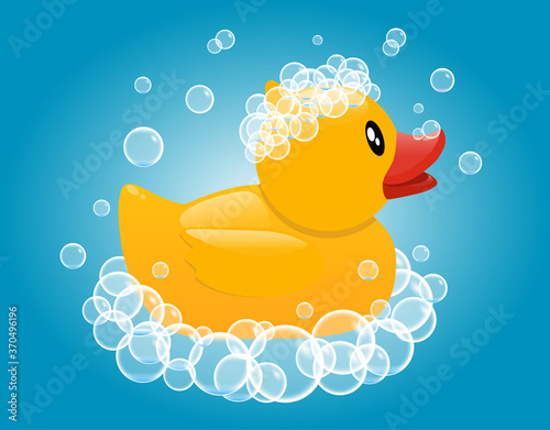 Yellow rubber duck in soap foam. Baby bathing toy. Vector cartoon illustration on a blue background.