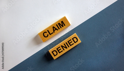 'Claim denied' words on wooden blocks. Business concept. Beautiful white and blue background. Copy space. photo