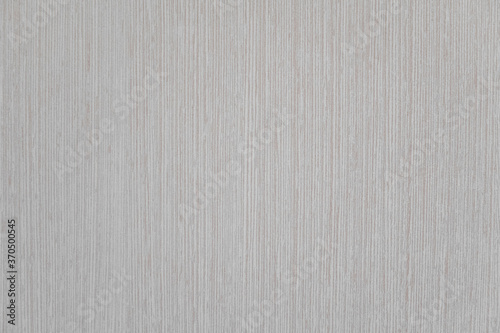 Texture of gray vinyl wallpaper for painting with vertical stripes patterns, closeup view.