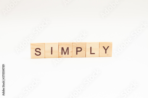 Word SIMPLY made of wooden blocks on white background.