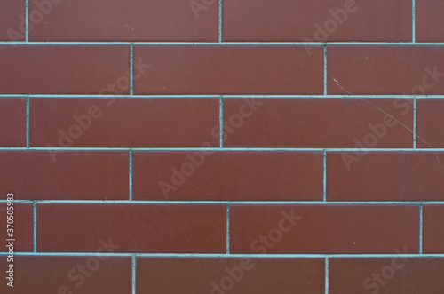 Stone tiles on the wall. The wall is made of ceramic, granite tiles. The structure of the stone.