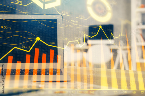 Stock market graph and table with computer background. Double exposure. Concept of financial analysis.