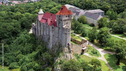 Liechtenstein Castle from the sky during sunset. The Liechtenstein Castle, situated on the southern edge of the Vienna Woods, Austria. Breathaking view about a medieval castle. 4k footage photo