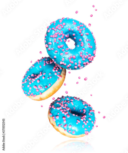 Donuts with blue glaze frozen in the air on a white background