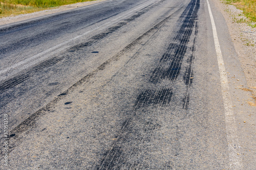 Tire tracks on the asphalt road. Brake traces