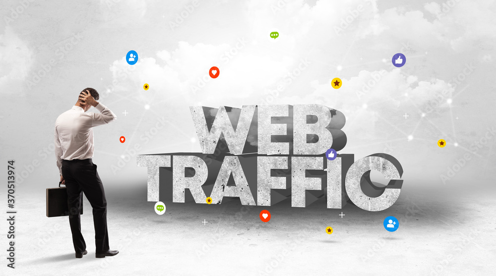 Young businessman standing in front of WEB TRAFFIC inscription, social media concept Young businessman standing in front of WEB TRAFFIC inscription, social media concept