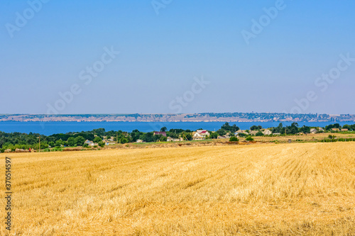 Beautiful view on agricultural field and river Dnieper on summer