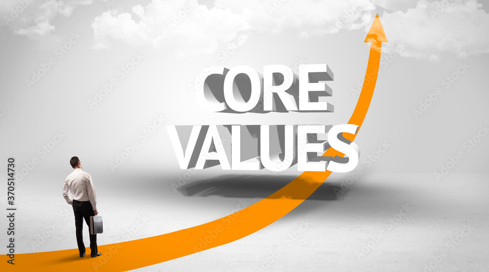 Rear view of a businessman standing in front of CORE VALUES inscription, successful business concept Rear view of a businessman standing in front of CORE VALUES inscription, successful business concept