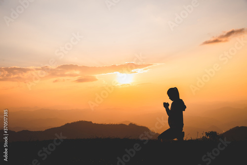 Religious young woman praying to God in the morning  spirtuality and religion  Religious concepts