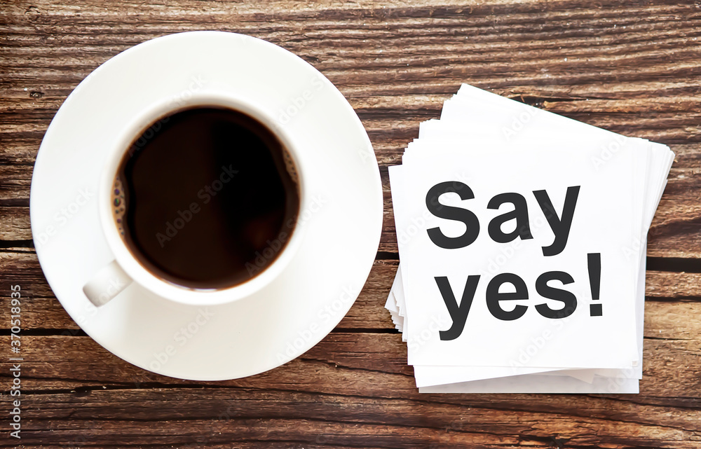 Word writing text Say yes . Business concept for Urgent Move.Text in stickers with a cap of coffee Word writing text Say yes . Business concept for Urgent Move.Text in stickers with a cap of coffee