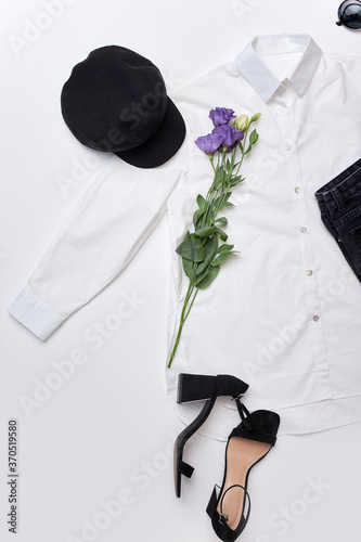 Картината върху платно elegant outfit for evening , top view on white blouse and black trousers wit accessories