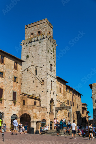 Nice portrait shot of la torre del Diavolo in San Gimignano, Tuscany. The tower at the northern side of the Piazza della Cisterna stands next to the cistern, capped by a travertine octagonal pedestal.