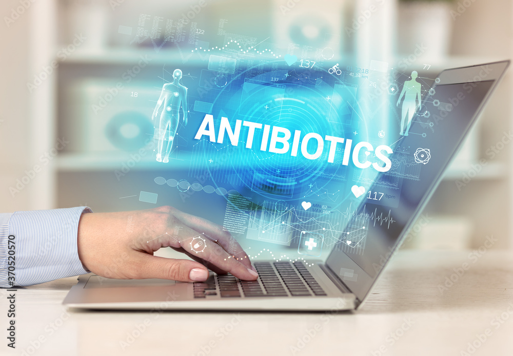 Doctor working a health check with ANTIBIOTICS inscription, recording medical test results Doctor working a health check with ANTIBIOTICS inscription, recording medical test results