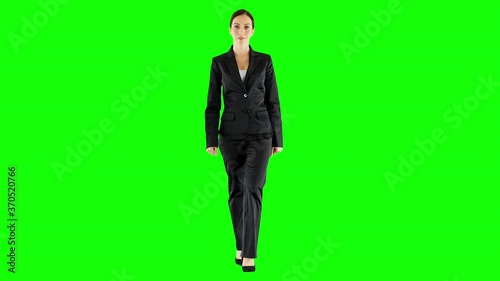 Front View of Young Smiling Businesswoman Walking on Green Screen