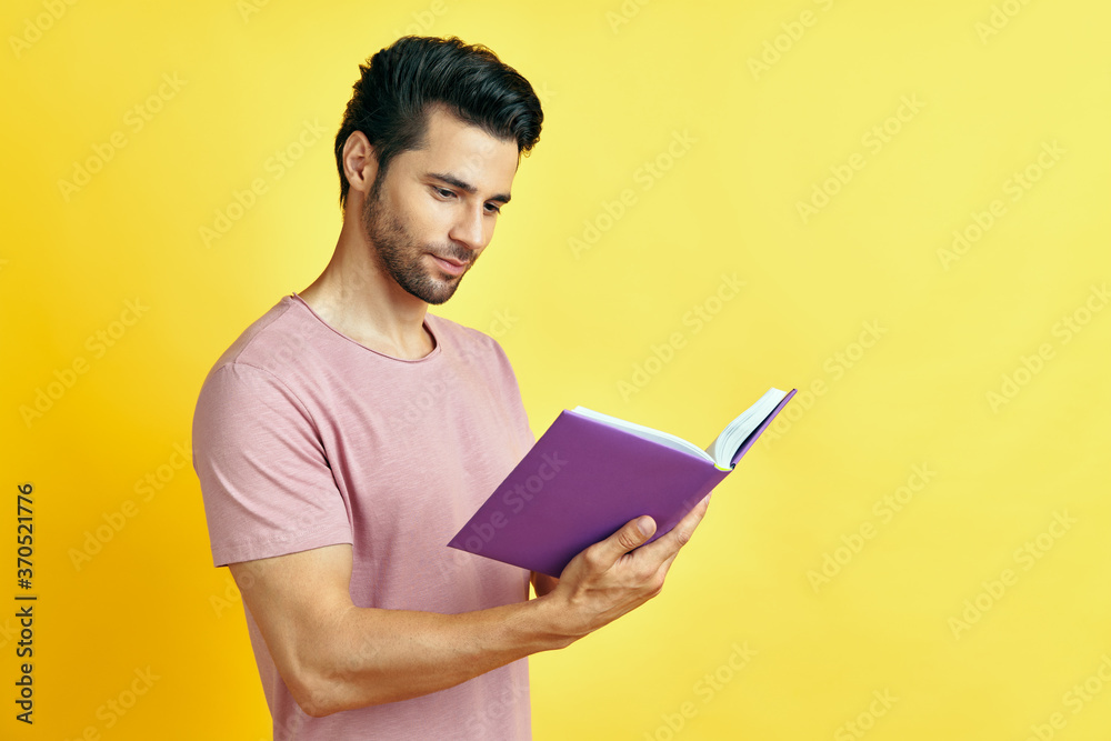Handsome young man in casual clothes reading a book Handsome young man in casual clothes reading a book