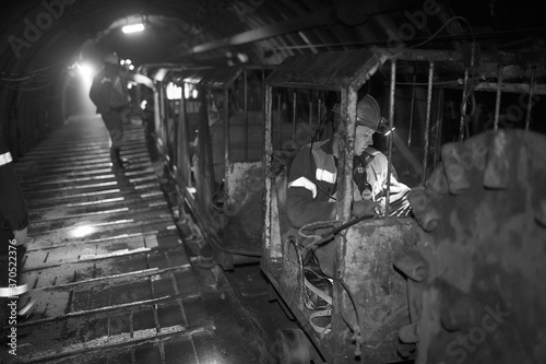 Silhouette of a working miner in a mine