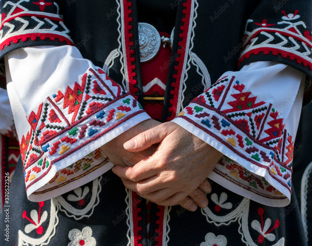 One hundred years be quiet Easy to happen Elements of traditional Bulgarian folk costume with embroidery. A Female  singer from Trakia folk ensemble and details of old, traditional dress.  Photographed in Plovdiv, Bulgaria Stock Photo | Adobe Stock