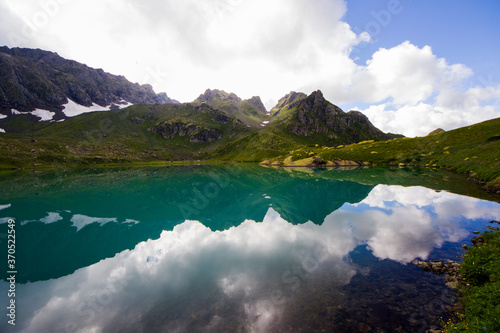 Alpine mountain lake landscape and view, blue beautiful and amazing lake panorama photo