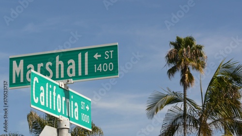 California street road sign on crossroad. Lettering on intersection signpost, symbol of summertime travel and vacations. USA tourist destination. Text on nameboard in city near Los Angeles, route 101