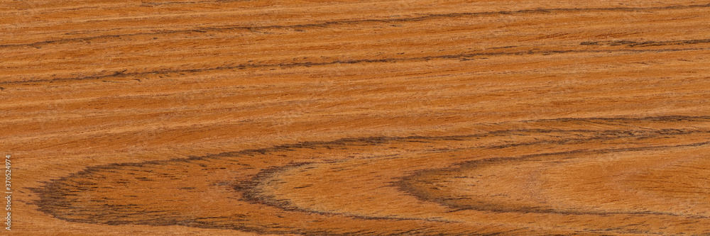 Attractive new teak veneer background in brown color. Natural wood texture, pattern of a long veneer sheet, plank. Attractive new teak veneer background in brown color. Natural wood texture, pattern of a long veneer sheet, plank.