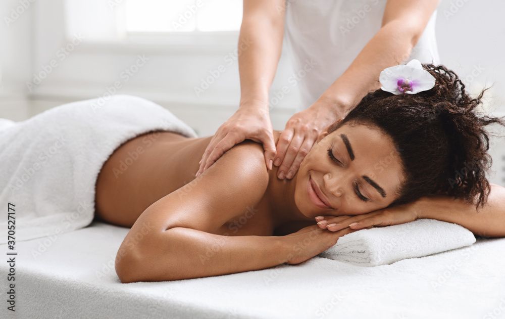 Relaxed black girl enjoying full body massage at new spa Stock Photo |  Adobe Stock