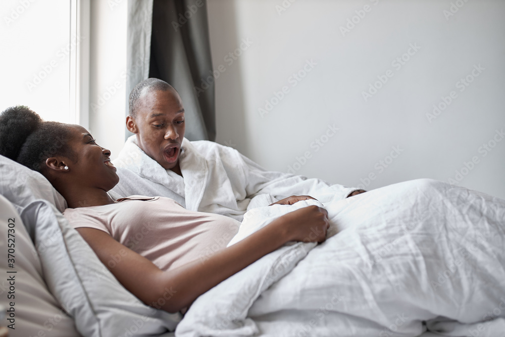 young black afroamerican man surprisingly looks at pregnant wife's belly, man is in shock, every day baby in stomach becomes bigger and bigger young black afroamerican man surprisingly looks at pregnant wife's belly, man is in shock, every day baby in stomach becomes bigger and bigger